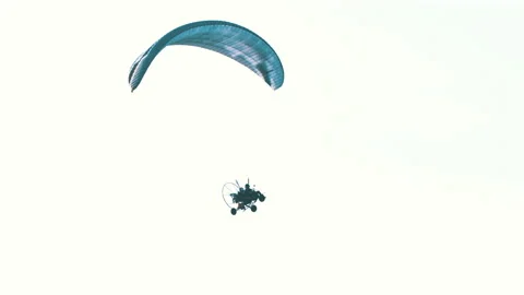 Tandem paramotorgliding, two paragliders flying against the bright white sky Stock Footage 139771445