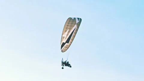 Tandem paramotorgliding, two paragliders flying against the bright blue sky Stock Footage 139771480