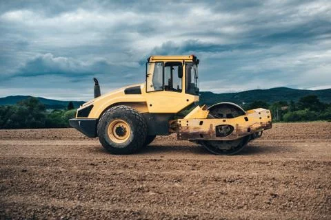 Tandem vibration roller compactor working on highway ground construction site Stock Photos