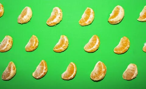 Tangerine pattern on a green background, top view Stock Photos