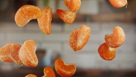 Tangerine sections in the air in slow motion Stock Footage 158306854