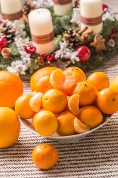 Tangerines and oranges on christmas table with advent wreath Stock Photos