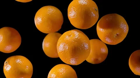 Tangerines are flying up on a black background Stock Footage 293241933