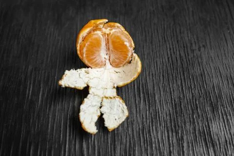 Tangerines on a black background. Lots of fresh fruit - mandarins. Stock Photos