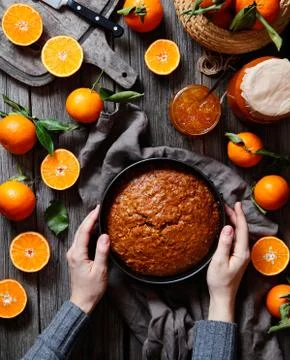 Tangerines compositions. Orange pie or tart, biscuit of citrus on a dark wooden Stock Photos