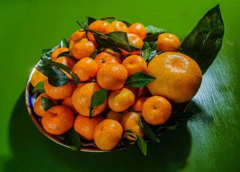 Tangerines on a green table. Stock Photos