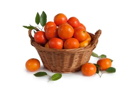 Tangerines with leaves in basket isolated on white background Stock Photos