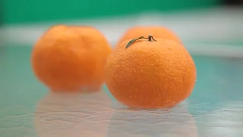 Tangerines lie on the table in the rain Stock Footage 170431336