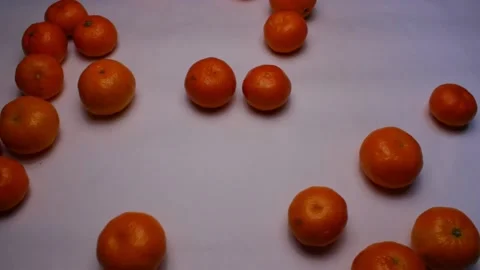 Tangerines rolling onto greyish table Stock Footage 145848194