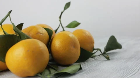 Tangerines rotating on a white table Stock Footage 98299920