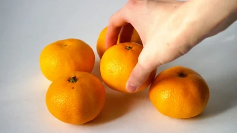 Tangerines on white background. I put tangerine. 2 Video stock 97707506