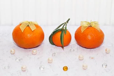 Tangerines on a white background, side view. Against the background of pearls Stock Photos