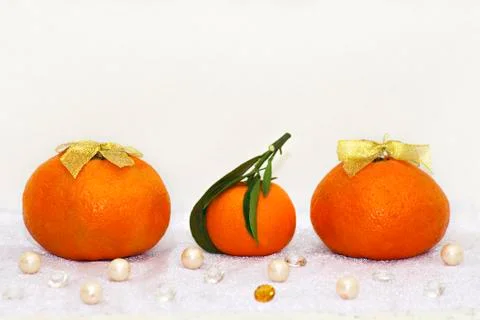 Tangerines on a white background, side view. Against the background of pearls Stock Photos