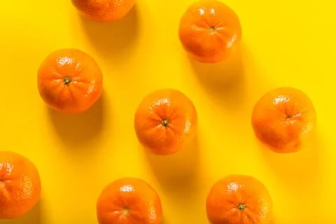 Tangerines on yellow Stock Photos