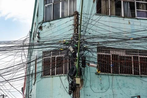 Tangle of cables, Cable clutter on an street power pole in Manaus, where ov.. Stock Photos
