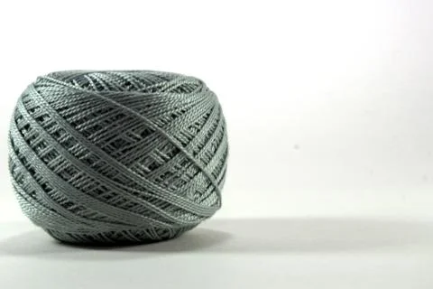 A tangle of gray cotton thread from natural cotton on a white background Stock Photos