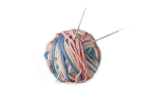 A tangle of multicolored threads and knitting needles Stock Photos