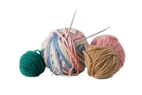 A tangle of multicolored threads and knitting needles Stock Photos