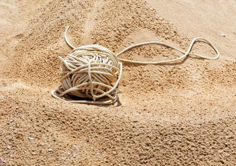 Tangle of rope lying on the sand Stock Photos