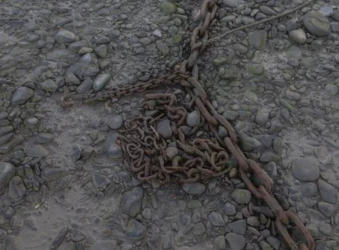 Tangle of rusty chains on the harbour floor Stock Photos