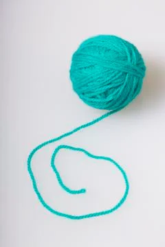 Tangle of thread for knitting emerald color on a white background. Stock Photos