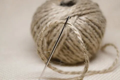 A tangle of thread rope with a large steel needle environmentally friendly mater Stock Photos