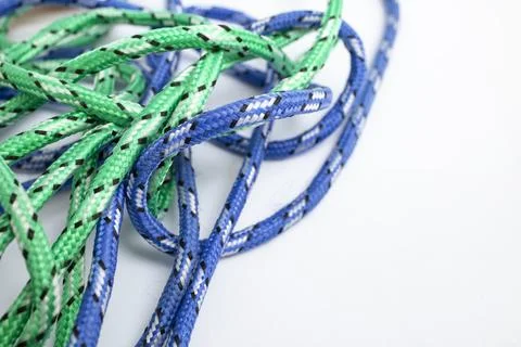 Tangled blue and green strings on white background with copy space Stock Photos