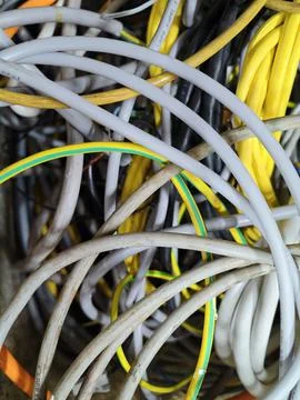 Tangled cables in cluttered indoor setting with plastic materials and close.. Stock Photos