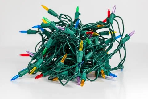 Tangled Christmas string lights isolated on white background. Stock Photos