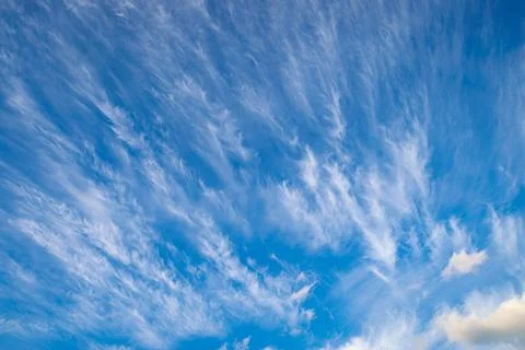 Tangled cirrus clouds in the blue sky Stock Photos
