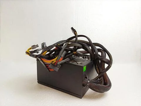 Tangled Computer Power Supply Unit With Sleeved Cables and Connectors Fotos de archivo