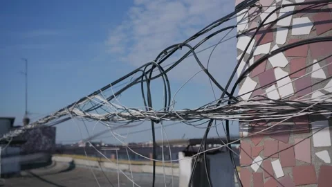 Tangled Internet Cables Hanging Along Urban Rooftop as Safety Hazard Stock Footage 347537437