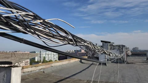 Tangled Internet Data Cables Stretching Across Sunny Urban Rooftop Видео 347546017