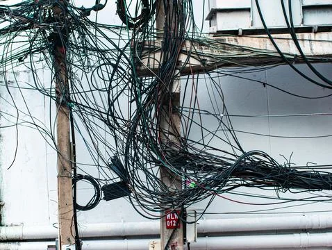 Tangled Overhead Electrical Wires on Utility Pole, Chaotic Urban Cable Mess.. Stock Photos
