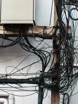 Tangled Overhead Electrical Wires on Utility Pole, Chaotic Urban Cable Mess.. Stock Photos