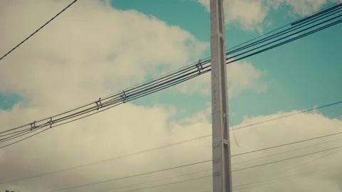 Tangled power lines span across a cloudy sky Stock Footage 337861886