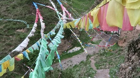 Tangled Tibet prayer flags hanging deep in the mountains Stock Footage 74642305