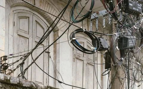 A tangled web of modern cables and coiled fiber optics creates a stark urba.. Stock Photos