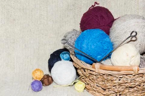 Tangles of of wool in a basket on table Stock Photos
