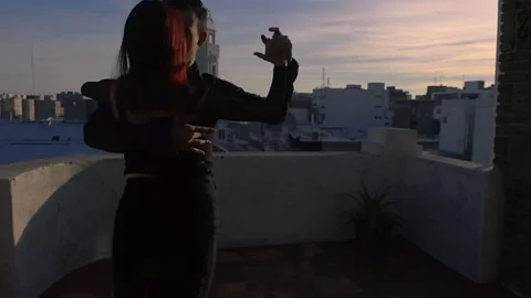 Tango couple dancing on a terrace overlooking montevideo Stock Footage 211129300