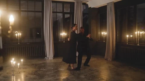 Tango dancers gracefully performing in a candlelit dark studio Stock Footage 284090638