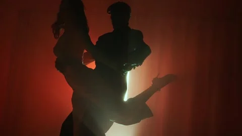 Tango Instructor and Student Performing Under Dramatic Lights Stock Footage 303366408