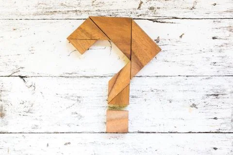 Tangram puzzle in question mark shape on old white wood background Stock Photos
