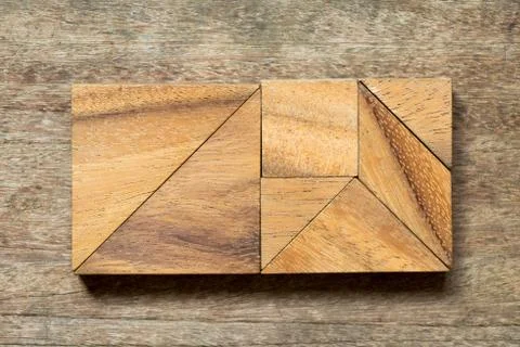 Tangram puzzle in rectangle shape on wood background Stock Photos