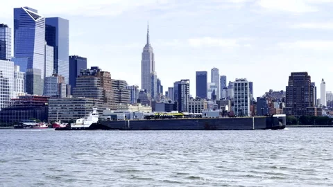A Tank Barge passing the Empire State Building New York City Stock Footage 332610187