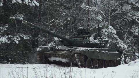 A tank drives through the forest in winter Stock Footage 266142356