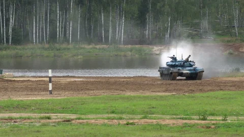 The tank drives through the range at high speed Stock Footage 138314335