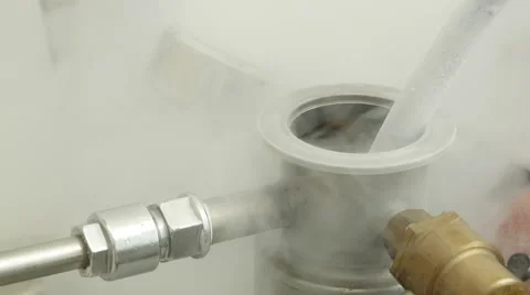 Tank with liquid nitrogen half covered by fume caused by evaporation Stock Footage 67421870