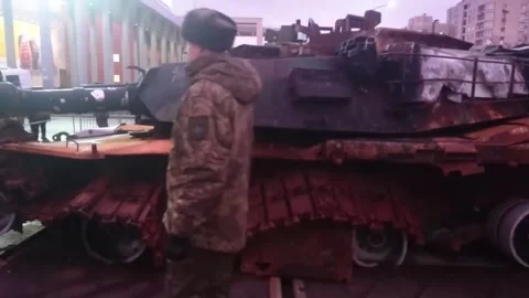 Tank M1 Abrams badly damaged, at outdoor exhibition of seized military equipment Stock Footage 299647359