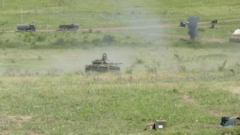 From a tank moving to a fighting position, a soldier throws shells from shells Stock-Footage 82805401